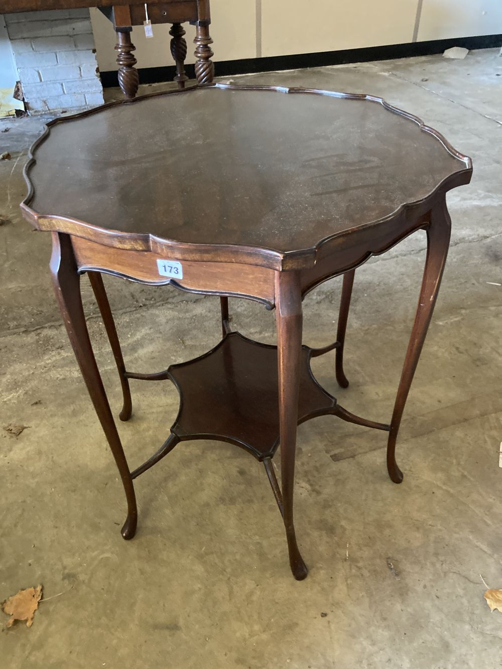 A late Victorian mahogany shaped circular topped two tier table, 67cm diameter, 72cm high